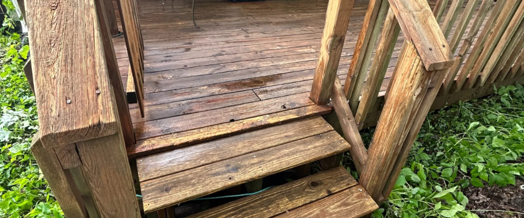 Old wooden deck stairs with worn boards before restoration