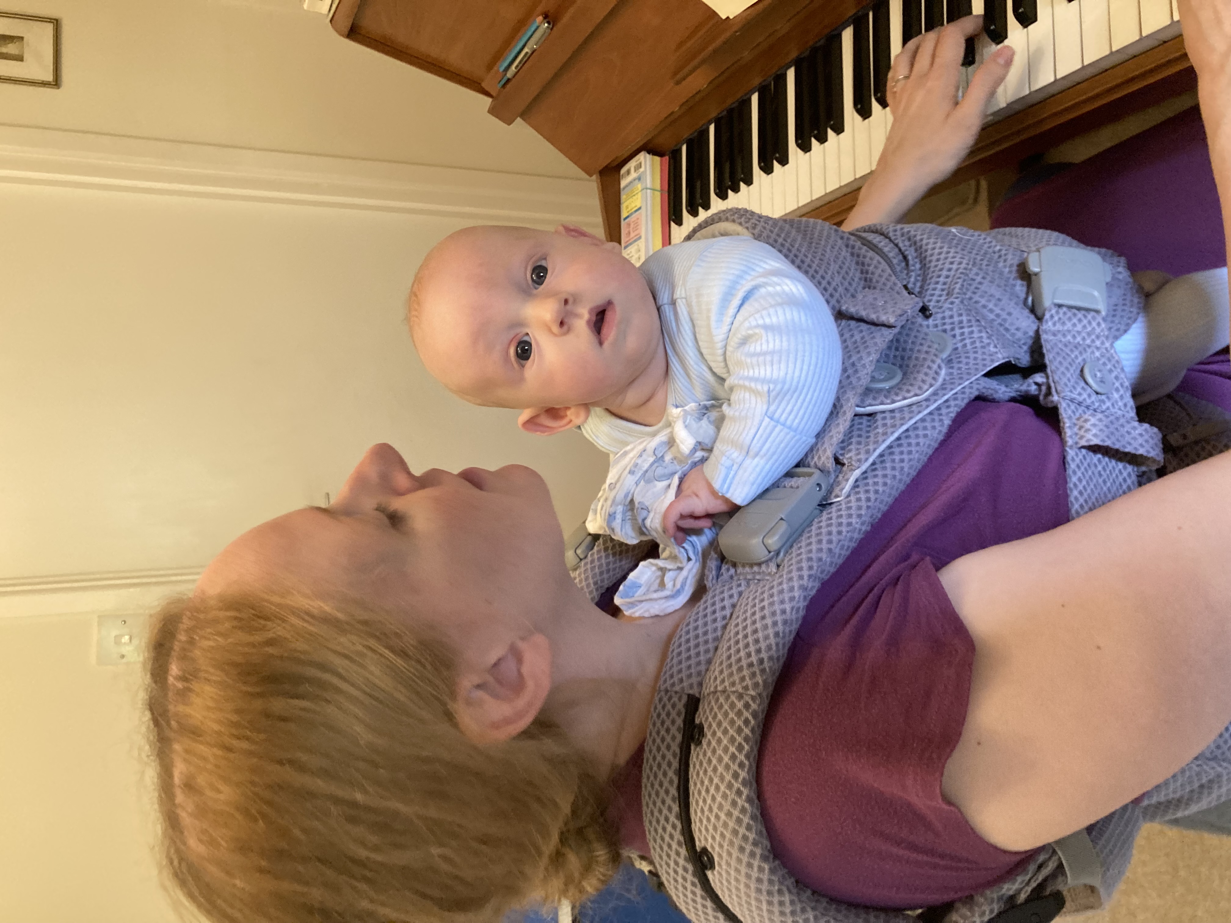 Baby at piano with piano teacher