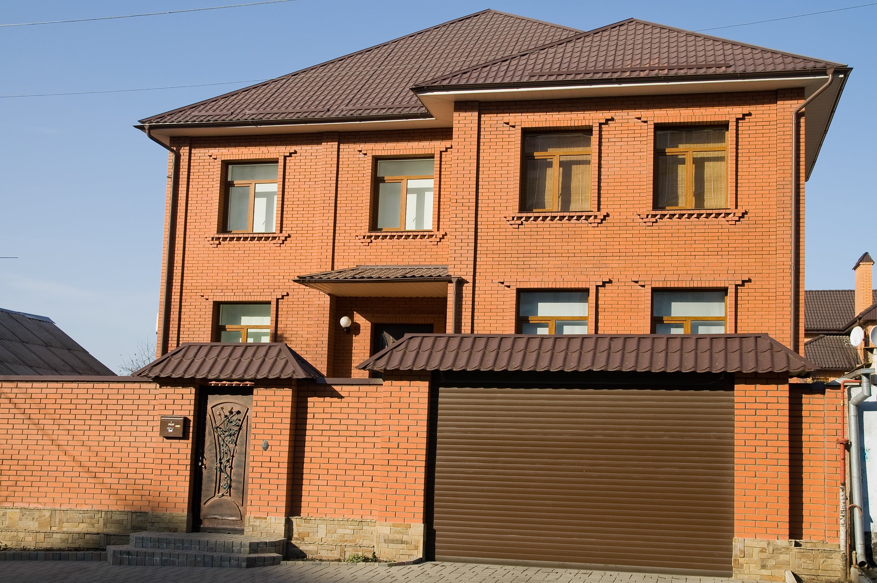 red house with red metal roofing