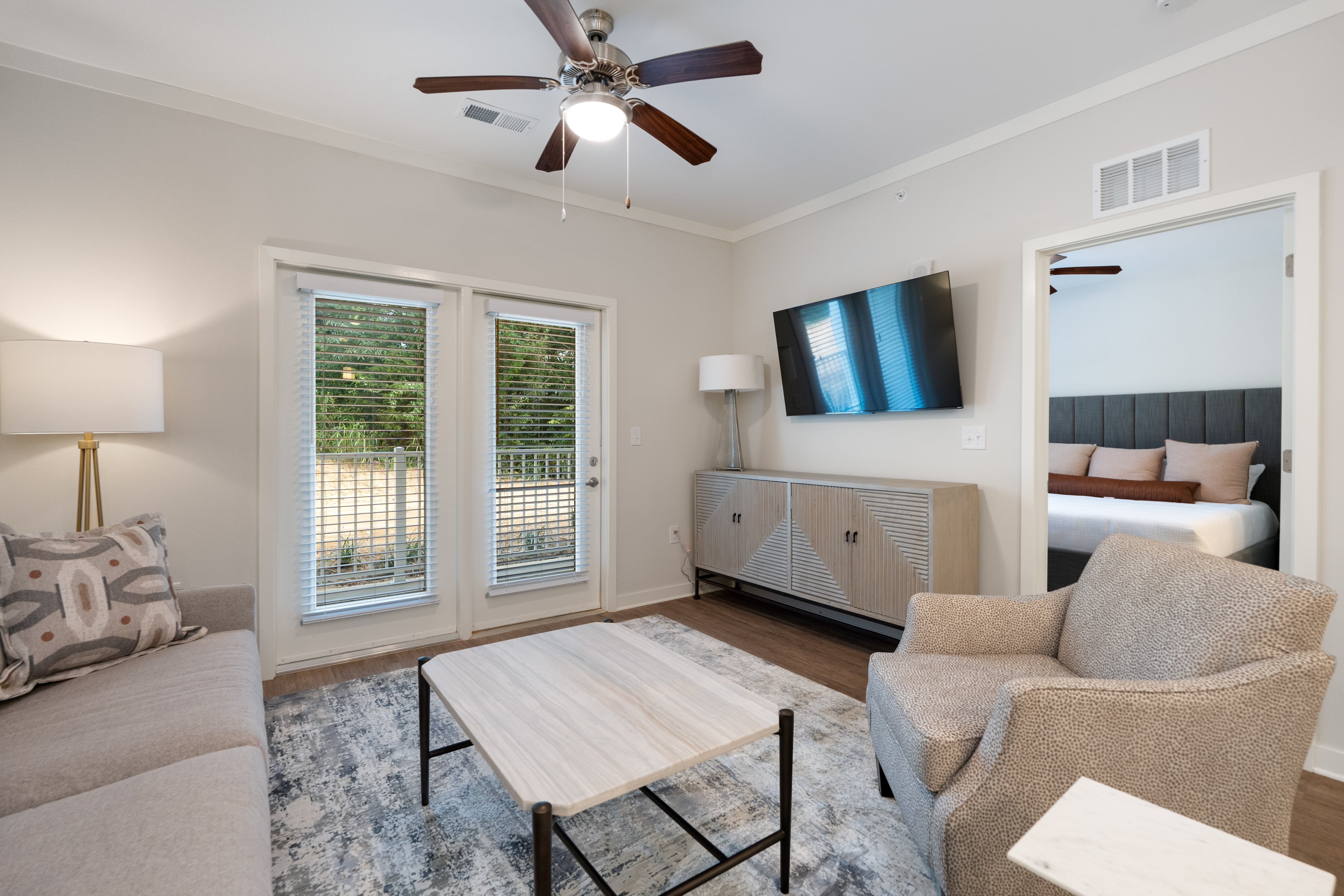 Living room view showing armchair and entryway to other rooms