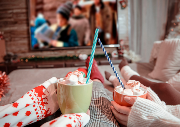 Two people enjoying hot chocolate in front of the fire and a calm home for the holidays