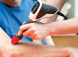Patient receiving shockwave therapy for elbow pain at Tucker Chiropractic in Blue Springs, MO Patient receiving shockwave therapy for elbow pain at Tucker Chiropractic in Blue Springs, MO