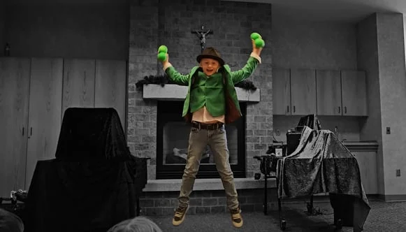 A kid magician in green