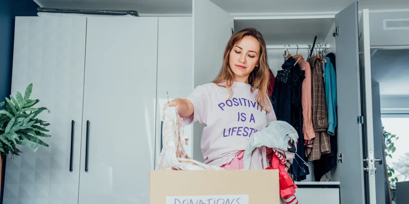 A person sorting through clutter in a room, representing the discovery and journey of decluttering A person sorting through clutter in a room, representing the discovery and journey of decluttering