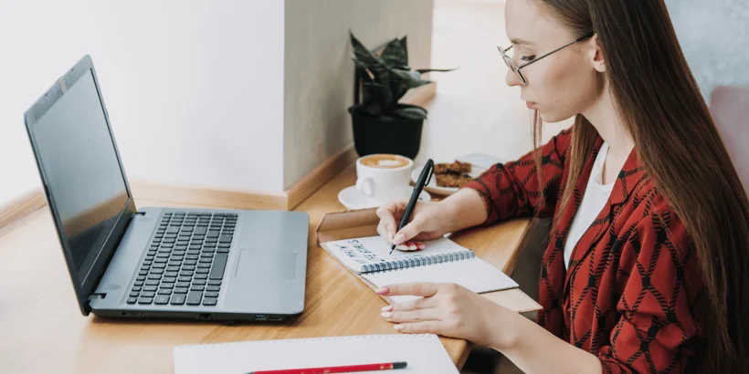 Woman setting goals in notebook Woman setting goals in notebook
