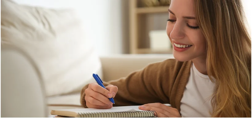 A person writing down personalized affirmations A person writing down personalized affirmations