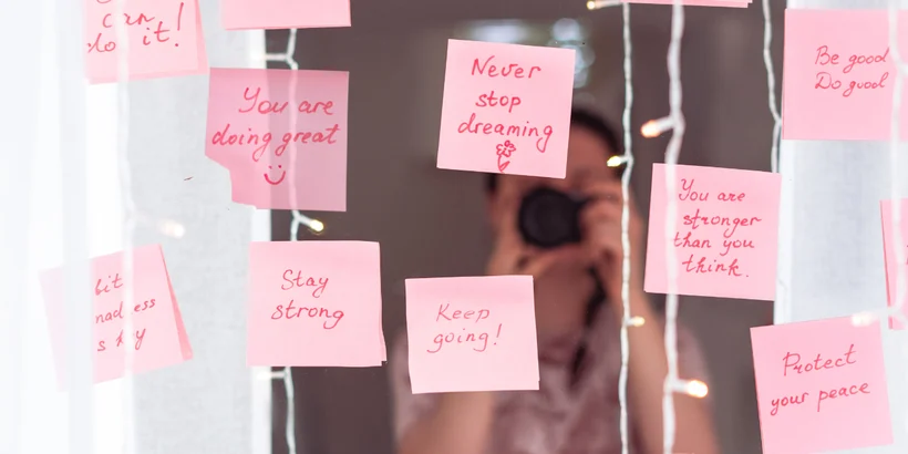 An image illustrating the meaning of what are affirmations, with a person holding a note card that reads 'I am worthy' surrounded by positive affirmations written on a whiteboard. An image illustrating the meaning of what are affirmations, with a person holding a note card that reads 'I am worthy' surrounded by positive affirmations written on a whiteboard.