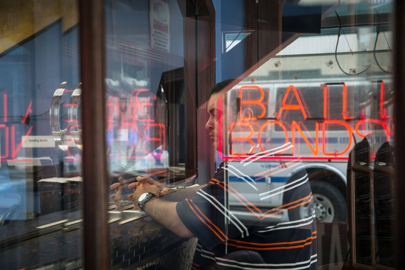 A man at a counter seeking bail agency services