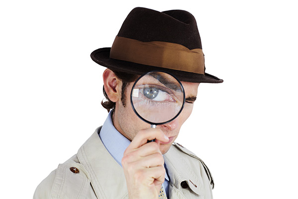 investigator looking through a magnifying glass investigator looking through a magnifying glass