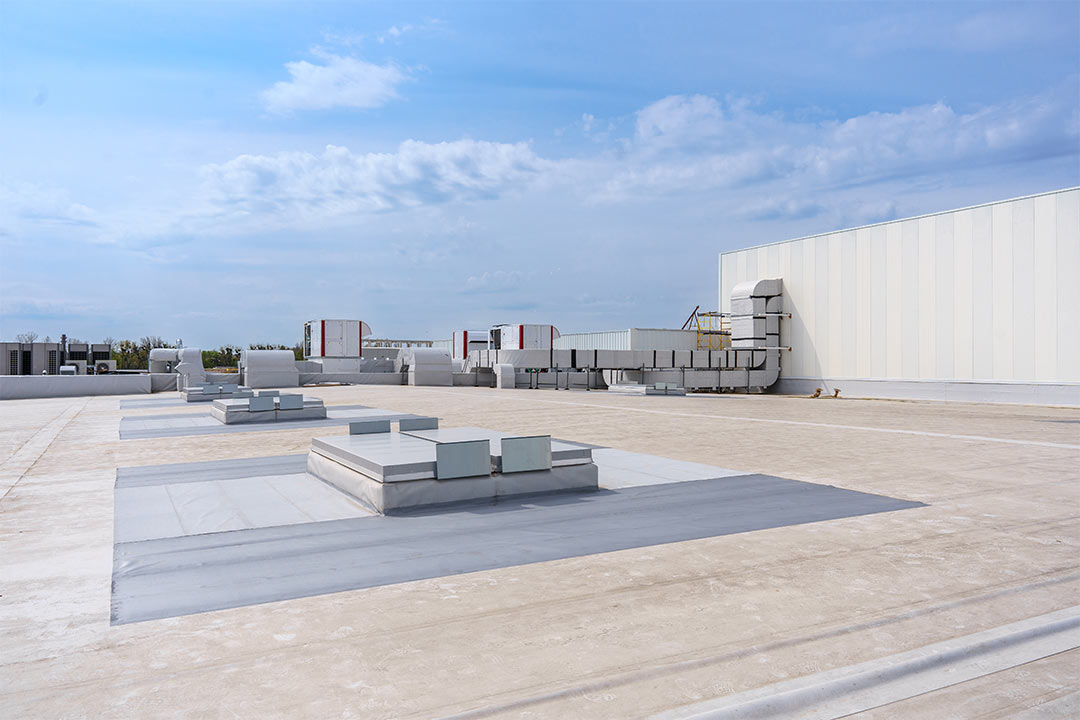 A commercial flat roof with HVAC units. A commercial flat roof with HVAC units.
