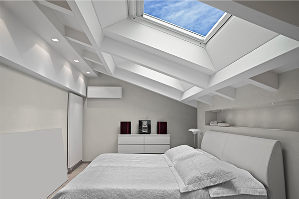 bedroom bathed in natural light from a skylight bedroom bathed in natural light from a skylight