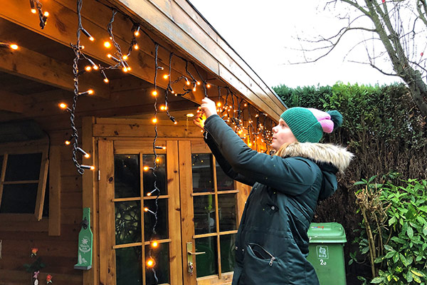 girl hangs up the Christmas lights girl hangs up the Christmas lights