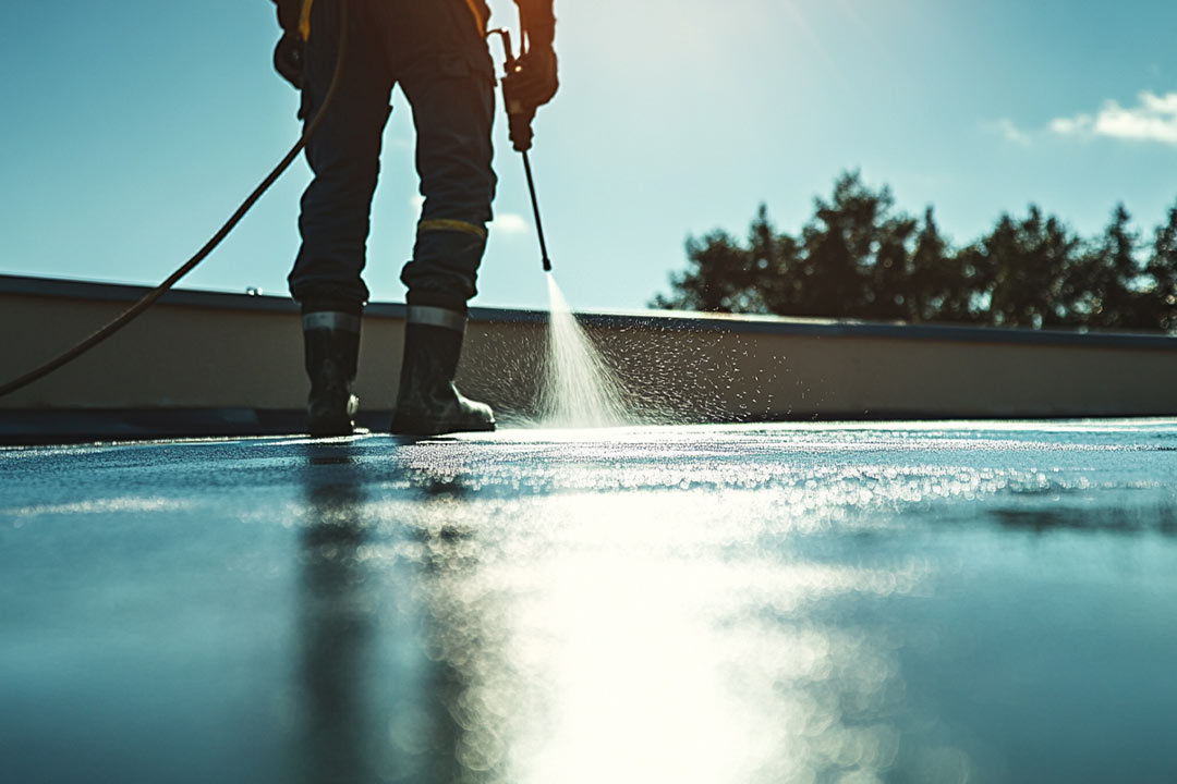 Application of a cool roof coating on a flat roof. Application of a cool roof coating on a flat roof.