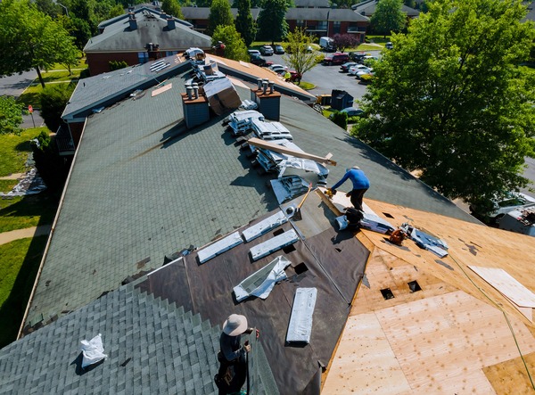 Roofers at work with skill and focus. Roofers at work with skill and focus.
