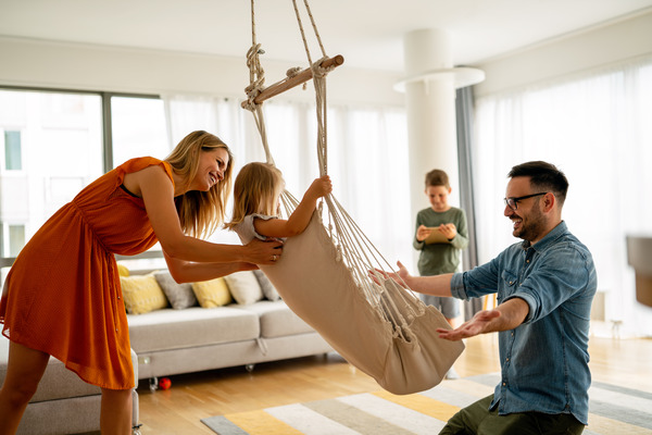 family relaxes comfortably indoors, enjoying each other's company family relaxes comfortably indoors, enjoying each other's company