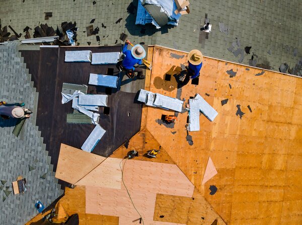 workers replace the roof with new materials for improved durability workers replace the roof with new materials for improved durability