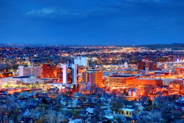 Evening cityscape showcasing urban rooftops, highlighting the vulnerability of roofs to hailstorm damage in densely populated areas. Evening cityscape showcasing urban rooftops, highlighting the vulnerability of roofs to hailstorm damage in densely populated areas.