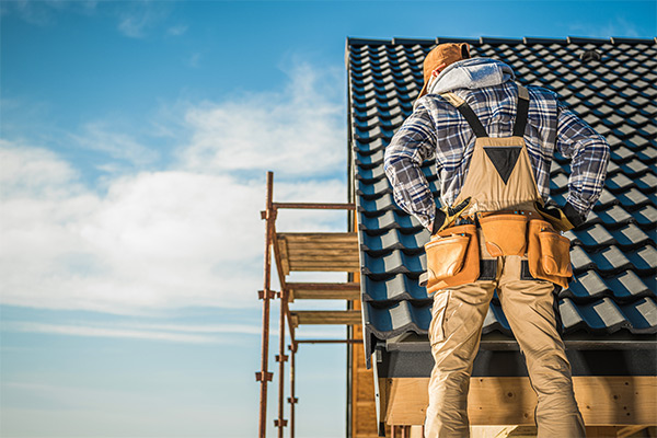 Roofer inspecting a newly installed metal roof, emphasizing durability and proper installation techniques for homeowners. Roofer inspecting a newly installed metal roof, emphasizing durability and proper installation techniques for homeowners.