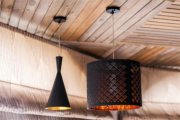 Stylish pendant lights hanging from a wooden ceiling, showcasing aesthetic and safe lighting installation methods. Stylish pendant lights hanging from a wooden ceiling, showcasing aesthetic and safe lighting installation methods.