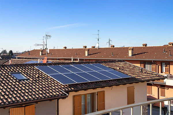 Home with solar panels installed on a tiled roof, showcasing a key 2023 roofing trend for energy efficiency and sustainability. Home with solar panels installed on a tiled roof, showcasing a key 2023 roofing trend for energy efficiency and sustainability.