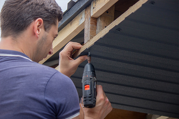 tightening a screw on a roof tightening a screw on a roof