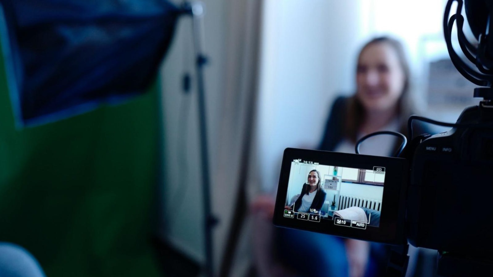 female social media influencer being recorded on video
