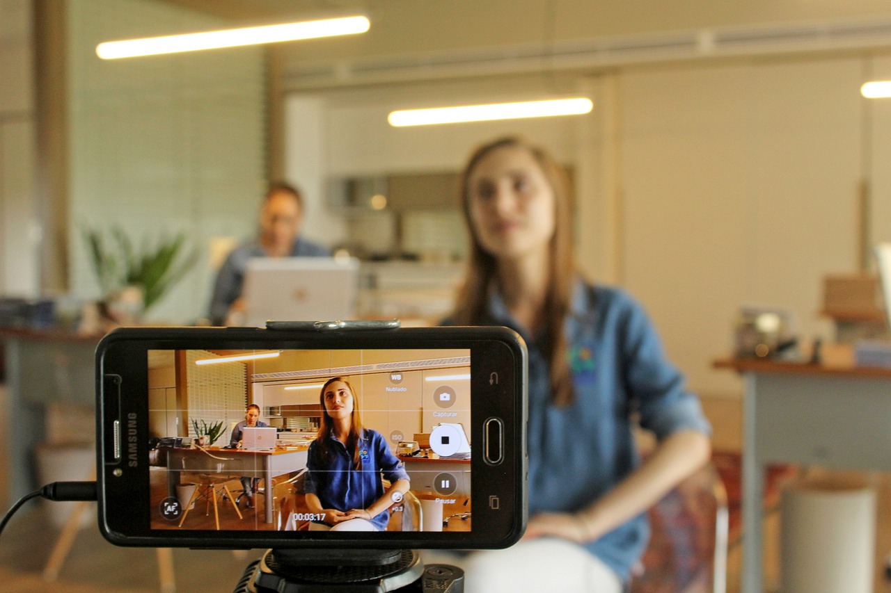 woman being videoed by phone