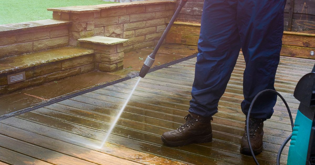 man applying spray in the deck man applying spray in the deck