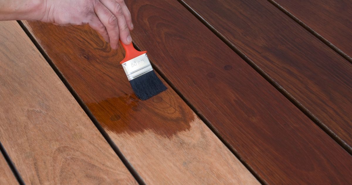man staining a deck man staining a deck
