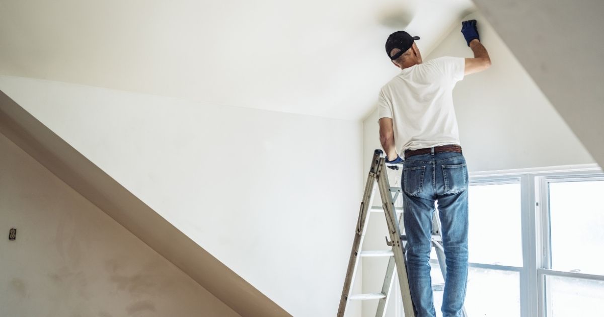 man painting wall man painting wall