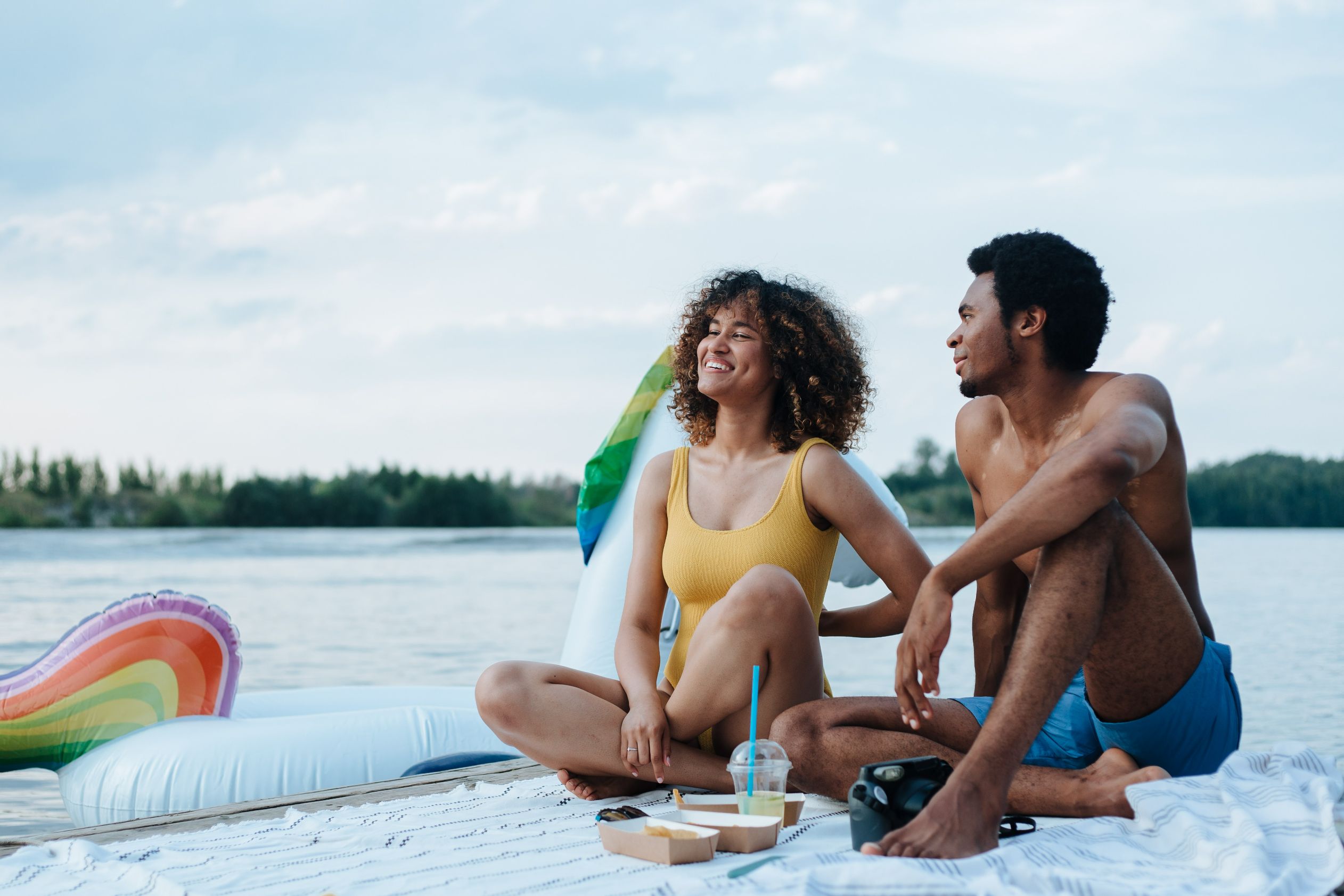 Fit couple enjoying food on the beach