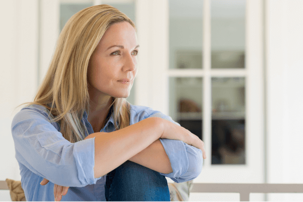 woman manifesting her dream life focussing on her goals looking out of the window woman manifesting her dream life focussing on her goals looking out of the window