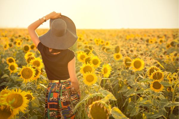 woman using a dopaine menu to boost her mood in a field of sunflowers woman using a dopaine menu to boost her mood in a field of sunflowers