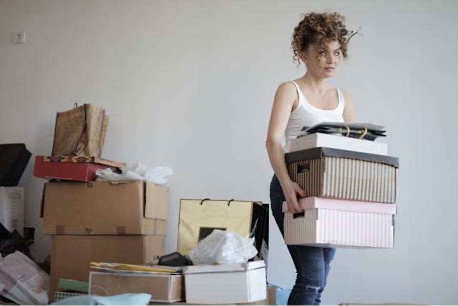 A woman carrying boxes