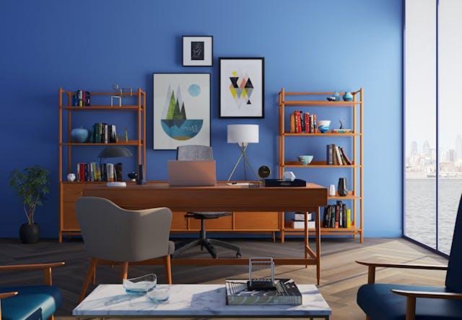 A room with a desk and shelves in the background