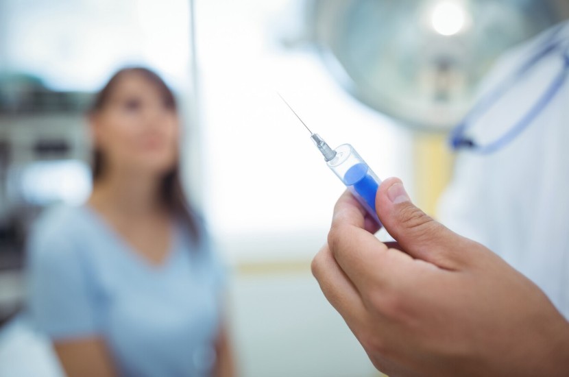Doctor preparing a syringe to give an injection Doctor preparing a syringe to give an injection