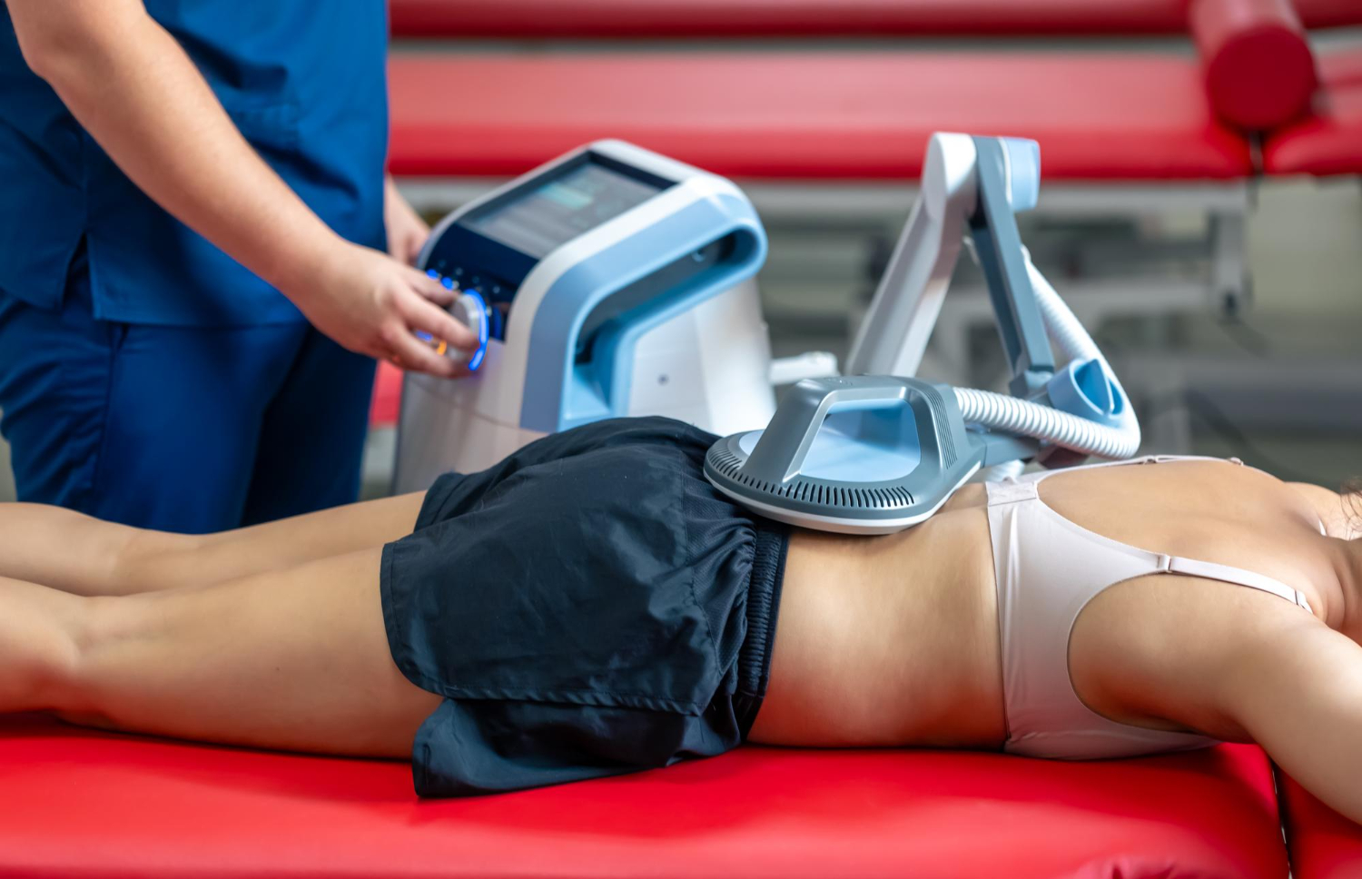 Electromagnetic therapy of the back physiotherapist doctor uses medical equipment Electromagnetic therapy of the back physiotherapist doctor uses medical equipment