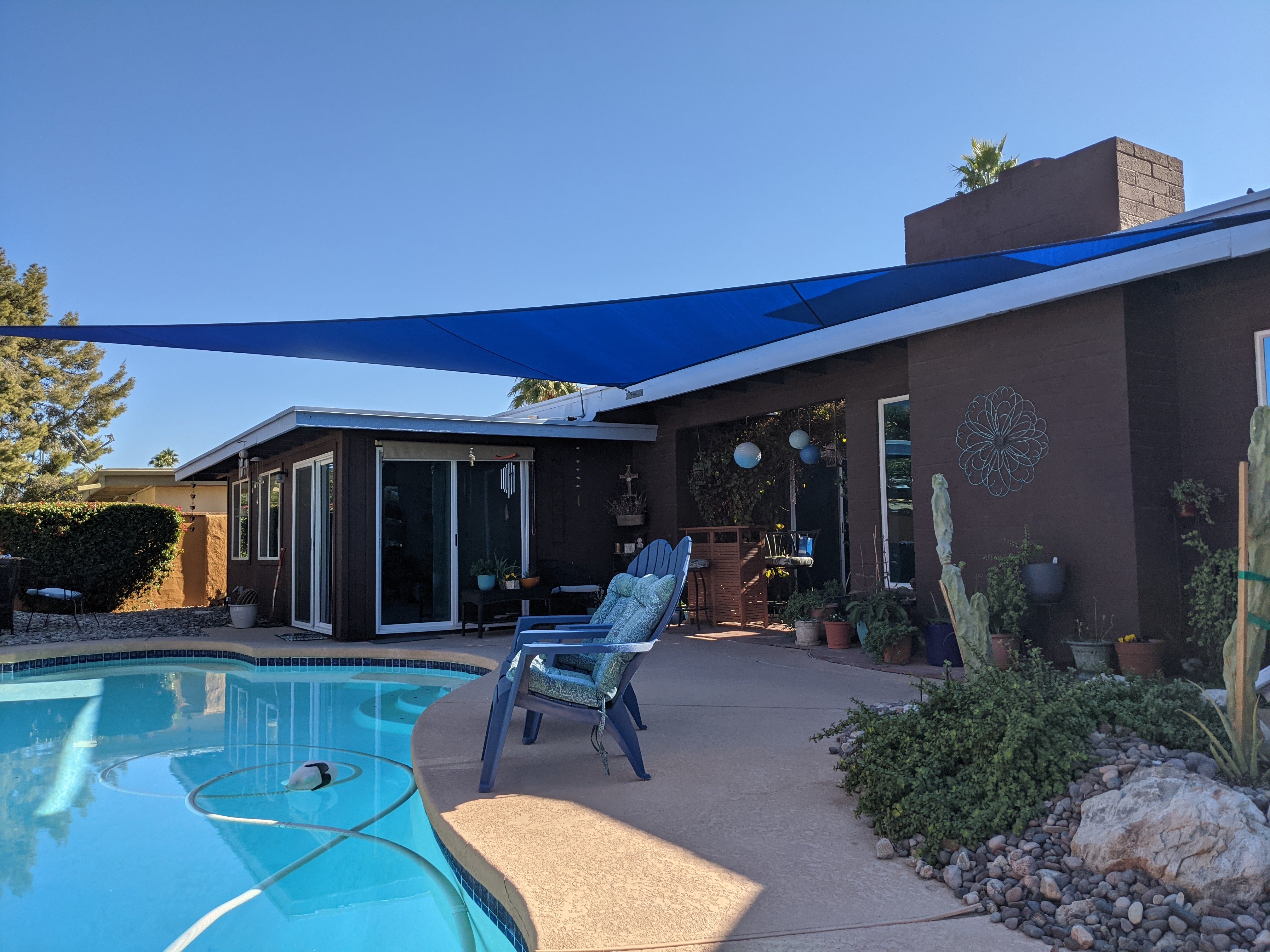 Blue shade sail installed over a residential pool and patio in Phoenix, Arizona by Shadeworks AZ