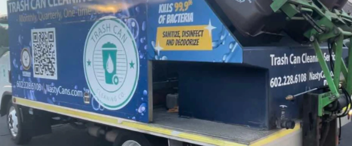 Nasty Cans branded trash can cleaning service truck parked in residential area.