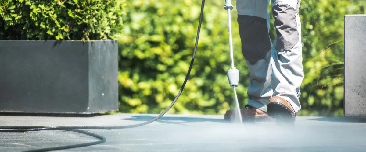 Professional pressure washing of concrete surface removing dirt and grime Professional pressure washing of concrete surface removing dirt and grime