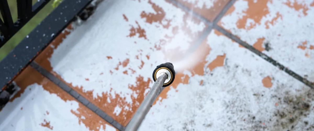 Pressure washing patio tiles to remove buildup, stains, and discoloration Pressure washing patio tiles to remove buildup, stains, and discoloration