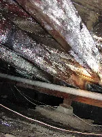 A close up of a wooden structure with a lot of dust on it.