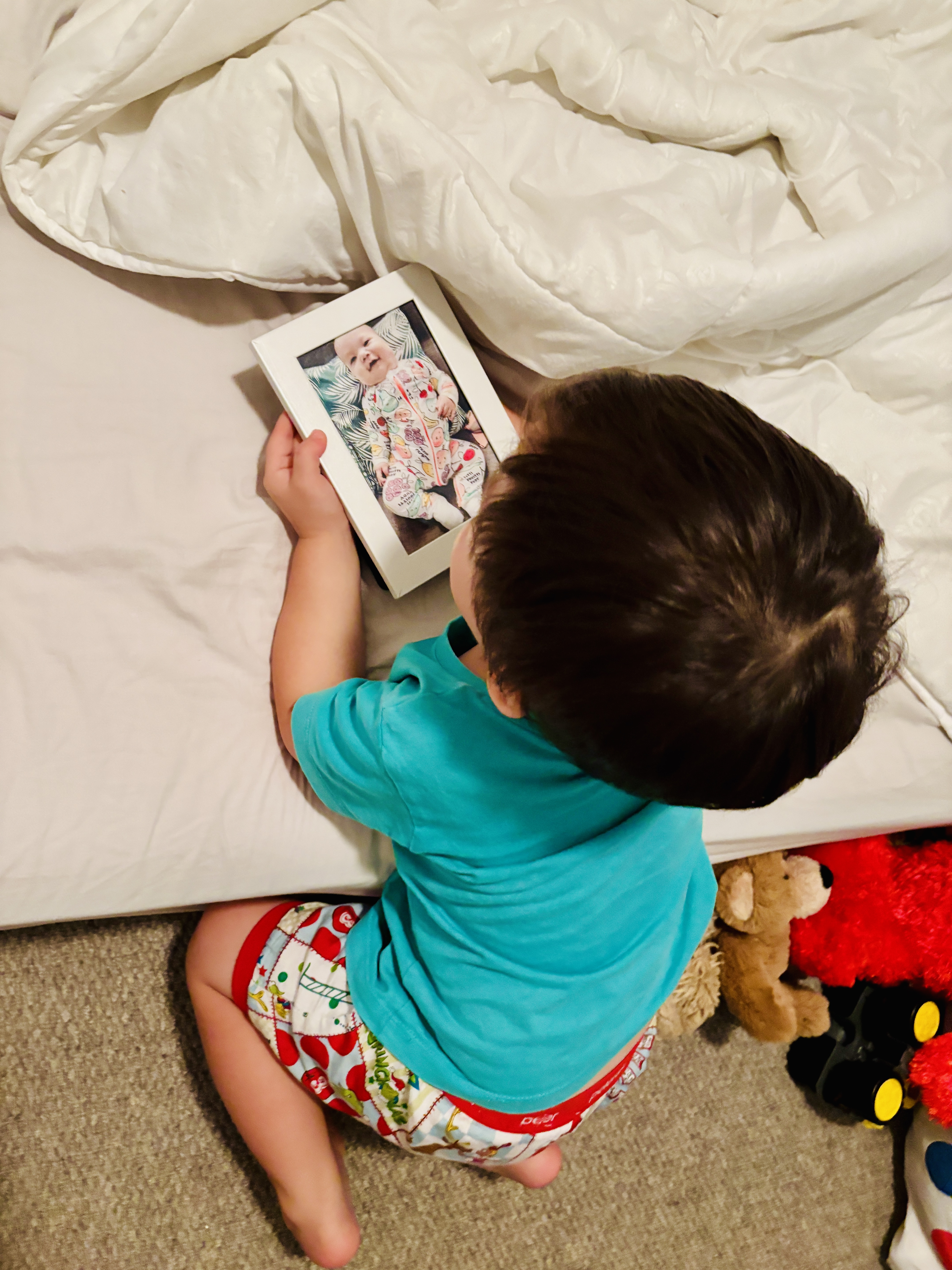 Child looking at picture of sibling