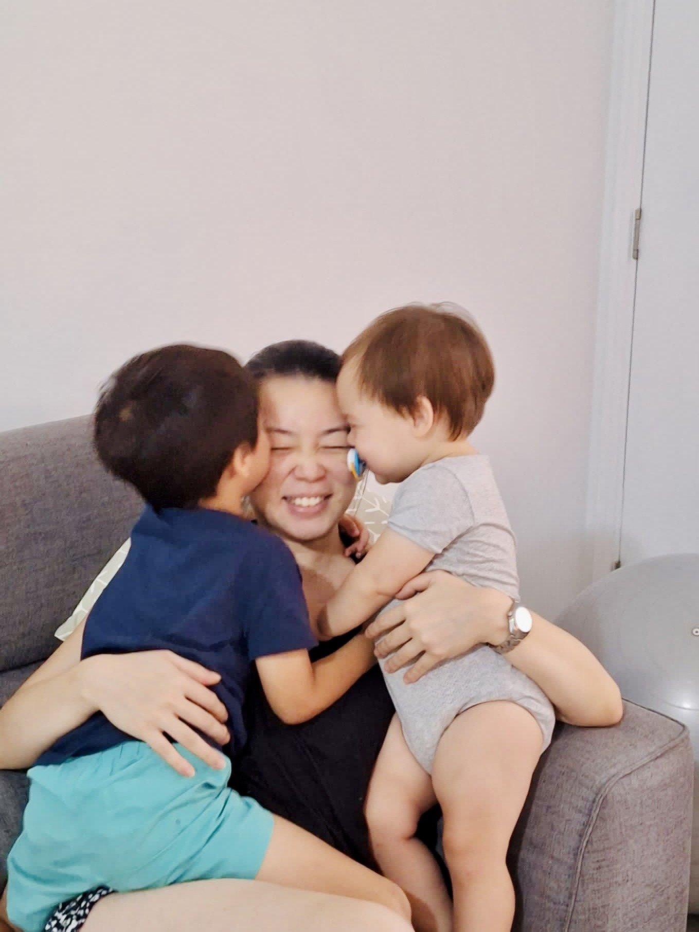 Mum hugging her children