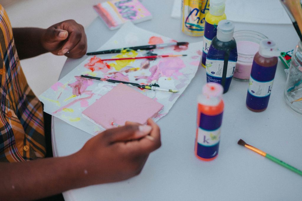 child doing finger painting art activities for preschoolers
