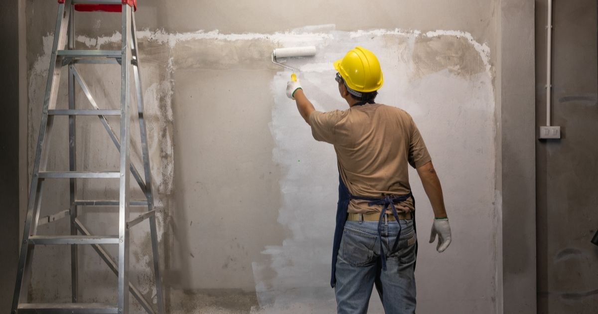 man applying primer in the wall man applying primer in the wall