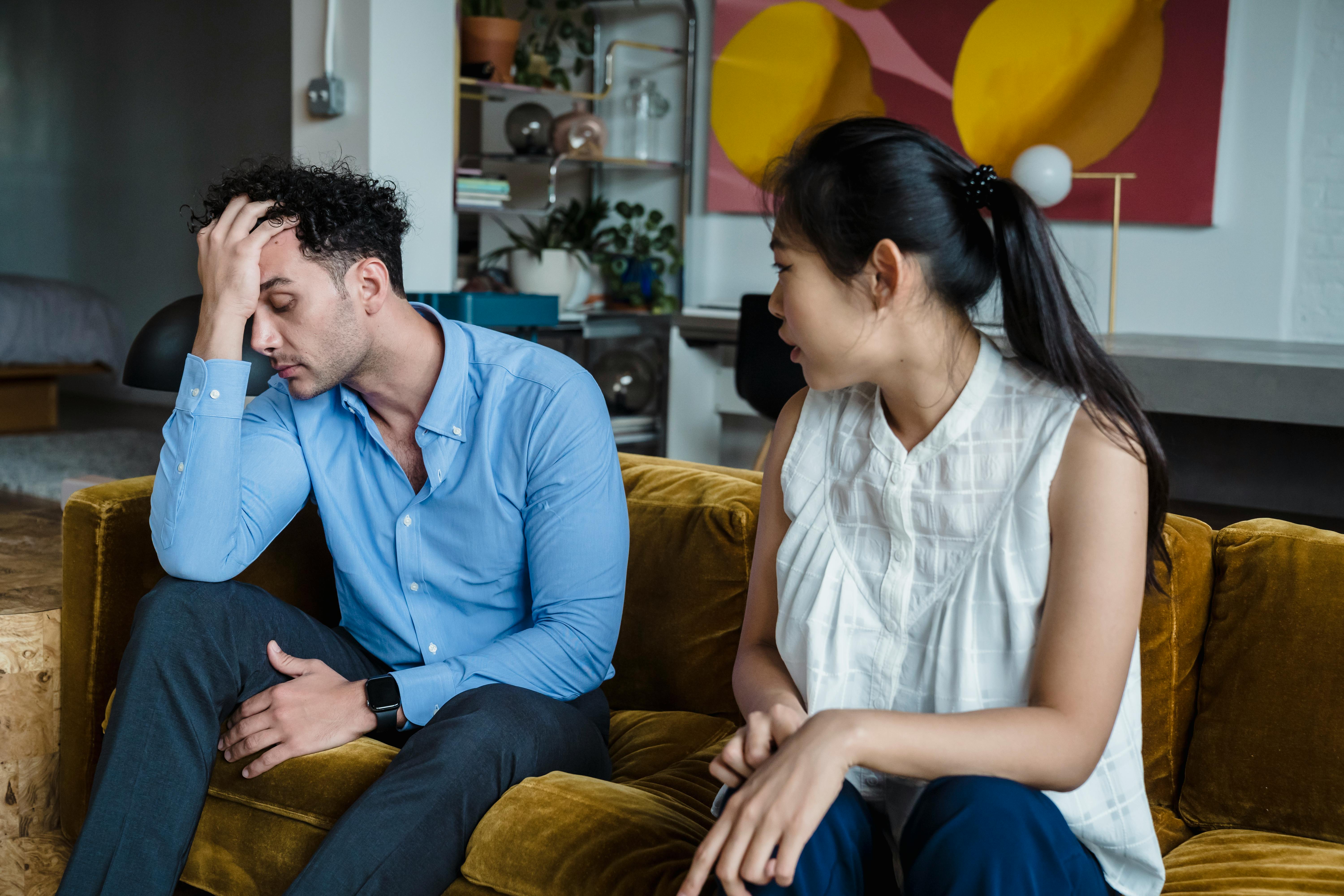 Frustrated couple arguing in a living room, expressing anger and disappointment – relationship conflict and communication issues. Frustrated couple arguing in a living room, expressing anger and disappointment – relationship conflict and communication issues.
