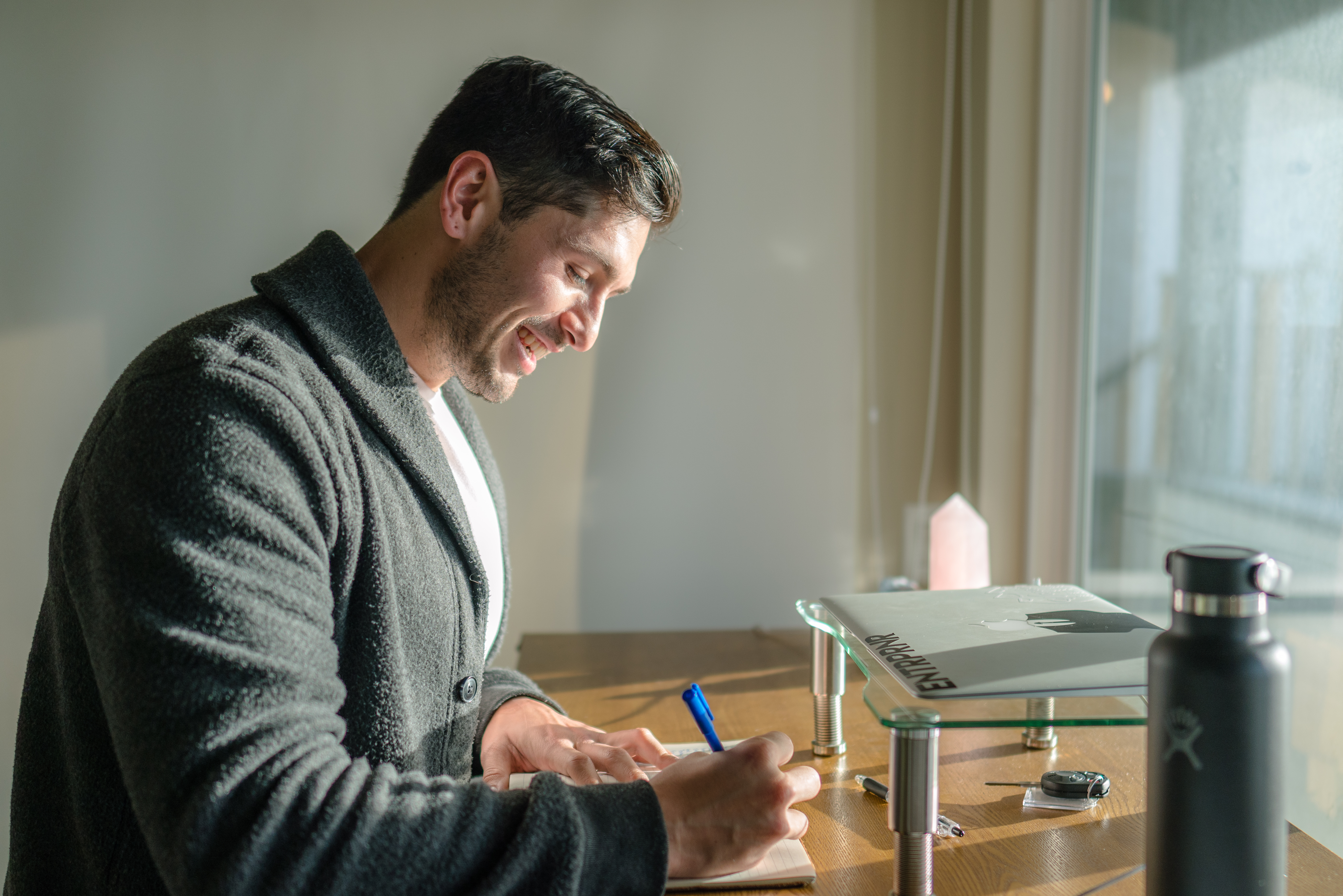 Joey Wilder sitting at a desk, focused on email marketing strategy with a laptop open and notes nearby. Joey Wilder sitting at a desk, focused on email marketing strategy with a laptop open and notes nearby.