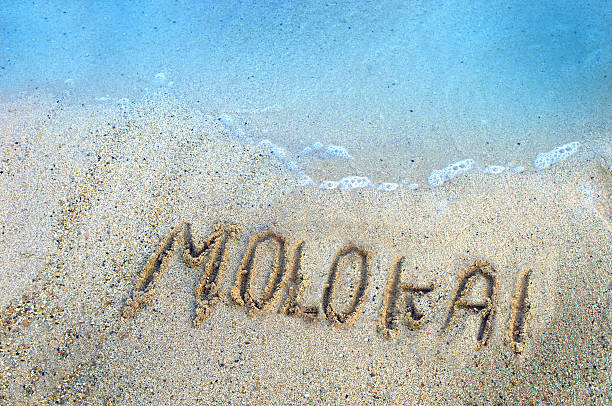 "molokai" written in the sand "molokai" written in the sand