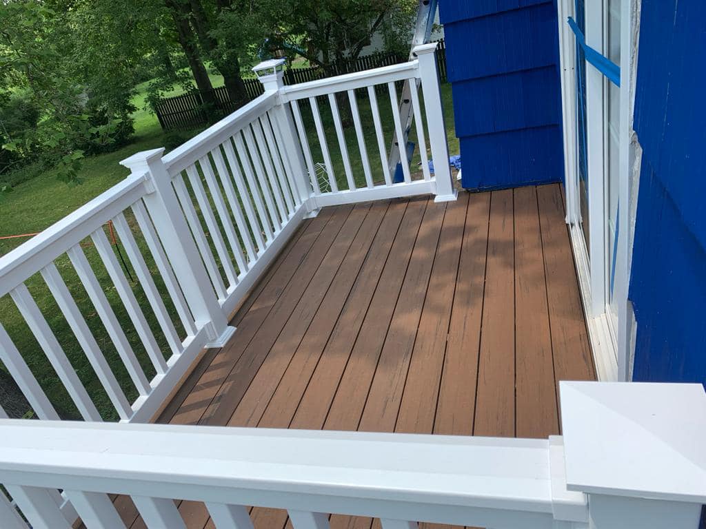 a newly installed deck with white fence